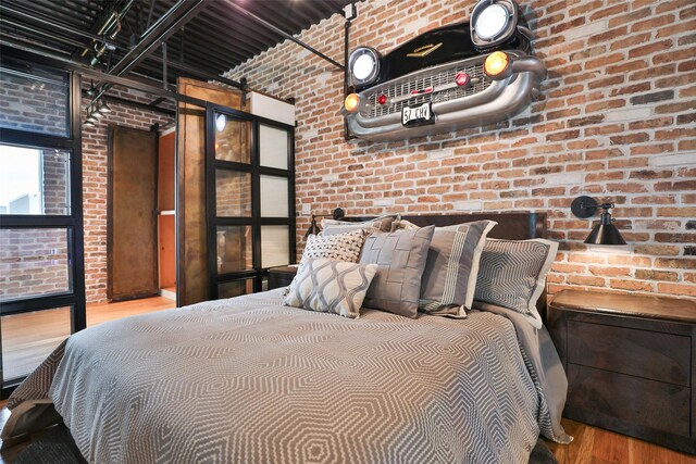1435 Fm 1463rd Rd Unit C14, Katy, TX 77494 - bedroom featuring brick wall, wood finished floors, and a barn door