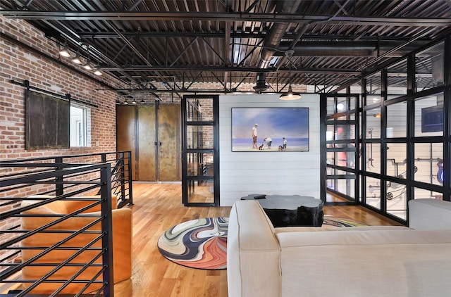 1435 Fm 1463rd Rd Unit C14, Katy, TX 77494 - living area featuring brick wall, wood finished floors, and a barn door