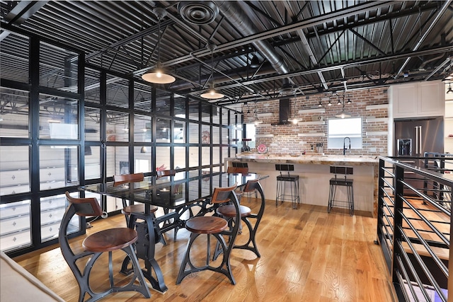 1435 Fm 1463rd Rd Unit C14, Katy, TX 77494 - dining room featuring brick wall and light wood finished floors