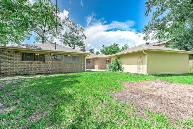 510 Shenandoah Dr, Shenandoah, TX 77381 - back of property featuring a lawn, brick siding, a chimney, and a shingled roof