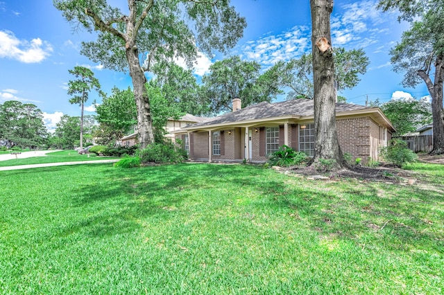 510 Shenandoah Dr, Shenandoah, TX 77381 - view of front of home featuring brick siding, a chimney, a front yard, and a shingled roof