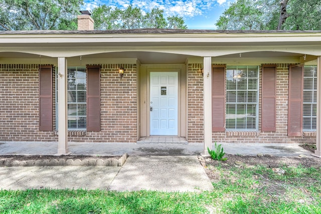 510 Shenandoah Dr, Shenandoah, TX 77381 - property entrance featuring a chimney and brick siding