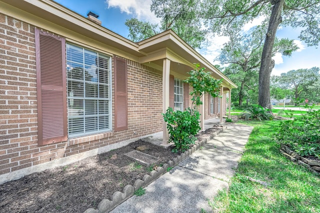 510 Shenandoah Dr, Shenandoah, TX 77381 - view of side of home featuring brick siding and a chimney