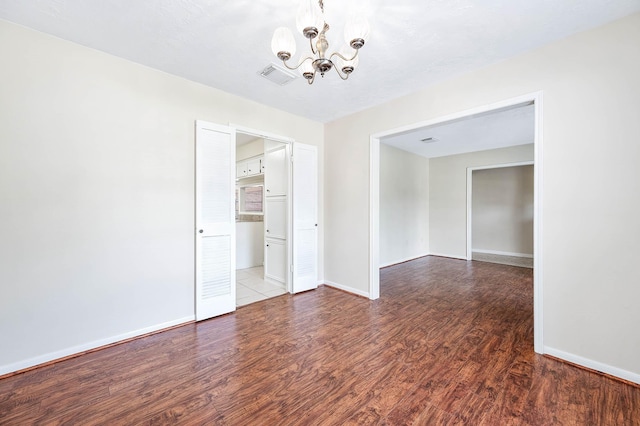 510 Shenandoah Dr, Shenandoah, TX 77381 - unfurnished room featuring a chandelier and wood finished floors