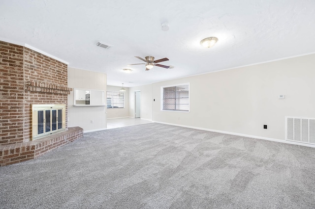 510 Shenandoah Dr, Shenandoah, TX 77381 - unfurnished living room with ceiling fan, carpet flooring, a fireplace, and a textured ceiling