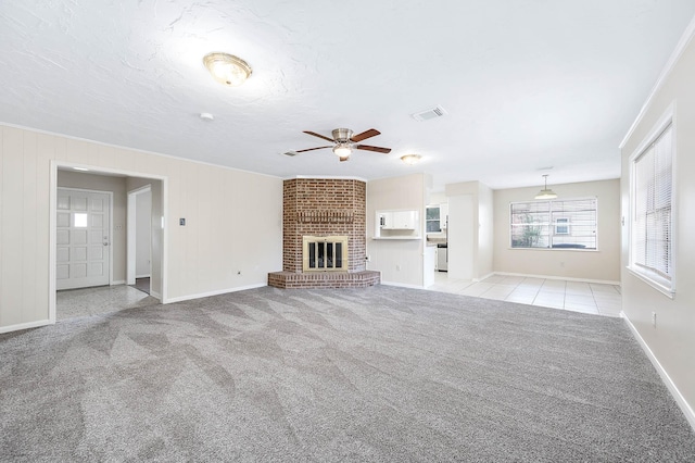510 Shenandoah Dr, Shenandoah, TX 77381 - unfurnished living room featuring ceiling fan, light colored carpet, and a brick fireplace