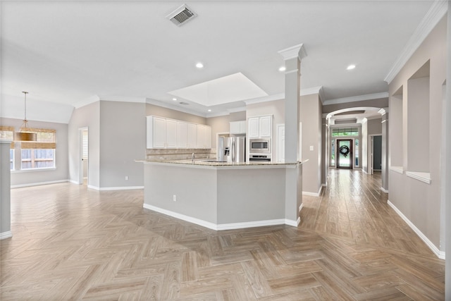 13718 Sherburn Manor Dr, Cypress, TX 77429 - kitchen featuring decorative columns, plenty of natural light, arched walkways, white cabinetry, and recessed lighting