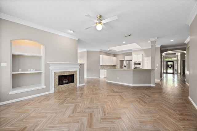 13718 Sherburn Manor Dr, Cypress, TX 77429 - unfurnished living room with ceiling fan, built in features, recessed lighting, ornamental molding, and a fireplace