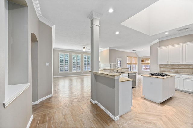13718 Sherburn Manor Dr, Cypress, TX 77429 - kitchen featuring ornamental molding, a center island, ceiling fan, open floor plan, and white cabinets