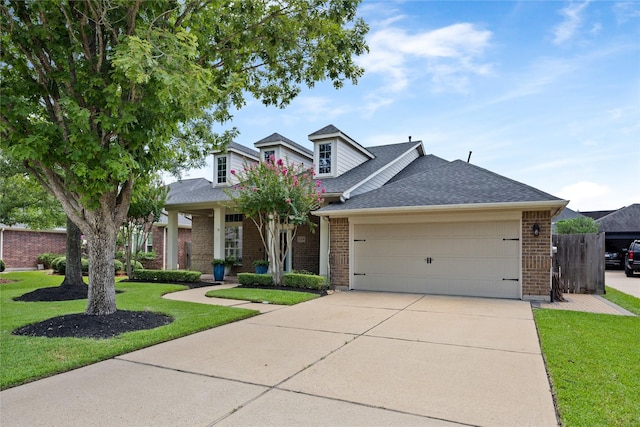 13718 Sherburn Manor Dr, Cypress, TX 77429 - view of front of home featuring roof with shingles, brick siding, driveway, and an attached garage