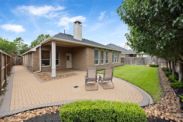 13718 Sherburn Manor Dr, Cypress, TX 77429 - back of property featuring a patio, brick siding, a fenced backyard, and a chimney