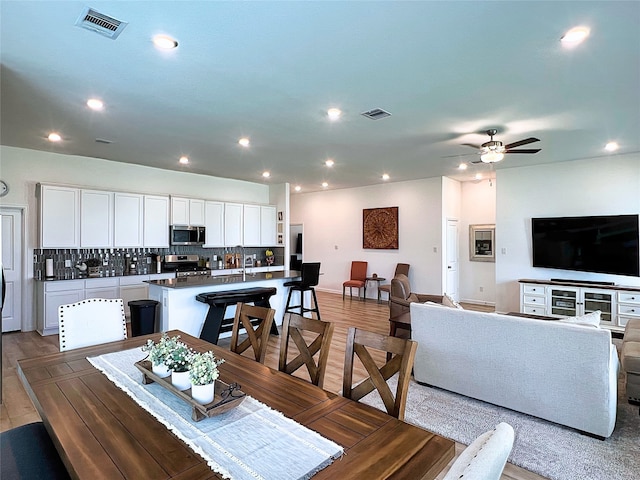 19022 Palizzi Ridge Ln, New Caney, TX 77357 - dining space featuring light wood-style floors, ceiling fan, and recessed lighting