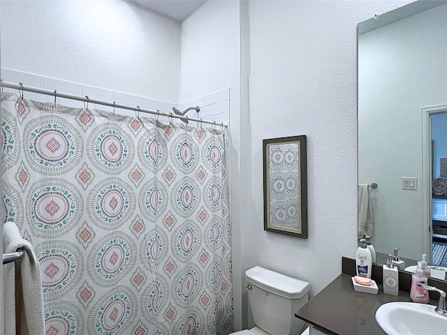 19022 Palizzi Ridge Ln, New Caney, TX 77357 - full bathroom with vanity, a shower with curtain, and a textured wall
