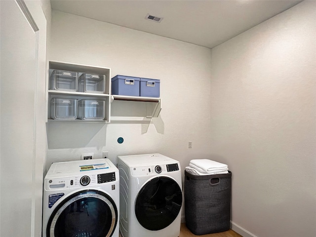 19022 Palizzi Ridge Ln, New Caney, TX 77357 - laundry area with washer and dryer and light wood-style flooring