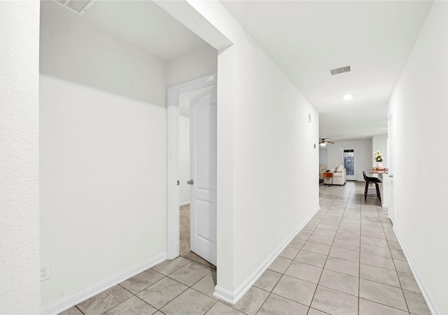 11642 Bodark Valley Ln, Houston, TX 77038 - hall featuring light tile patterned floors and baseboards
