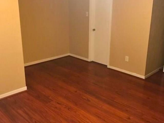 7900 Westheimer Rd Unit 112, Houston, TX 77063 - empty room featuring dark wood-style flooring and baseboards