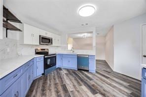 19314 Cypress Arbor Ct, Katy, TX 77449 - kitchen featuring stainless steel appliances, open shelves, dark wood finished floors, light countertops, and tasteful backsplash