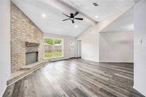 19314 Cypress Arbor Ct, Katy, TX 77449 - unfurnished living room with wood finished floors, a ceiling fan, and a fireplace