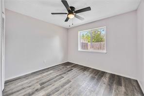 19314 Cypress Arbor Ct, Katy, TX 77449 - empty room featuring wood finished floors and ceiling fan