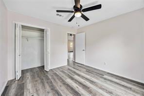 19314 Cypress Arbor Ct, Katy, TX 77449 - unfurnished bedroom with wood finished floors, a closet, and ceiling fan
