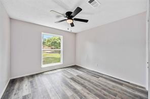 19314 Cypress Arbor Ct, Katy, TX 77449 - empty room featuring wood finished floors and ceiling fan