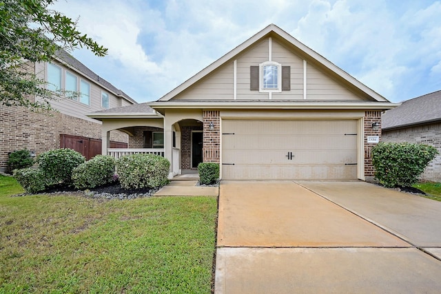 23014 Indigo Prairie Ln, Katy, TX 77493 - view of front facade featuring brick siding, covered porch, a garage, and driveway