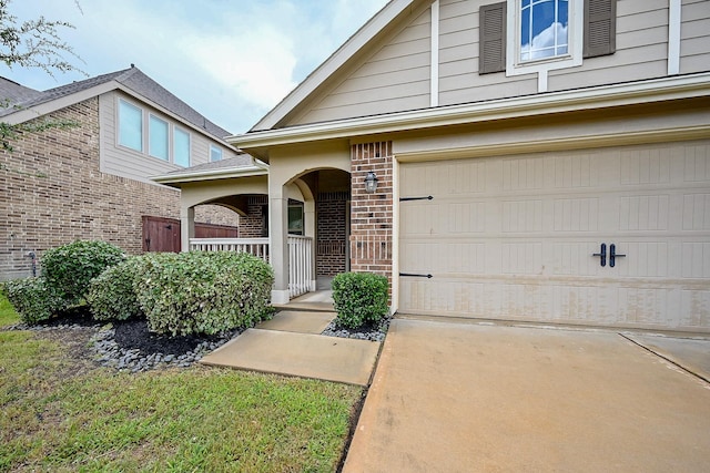 23014 Indigo Prairie Ln, Katy, TX 77493 - doorway to property featuring brick siding, a porch, and concrete driveway