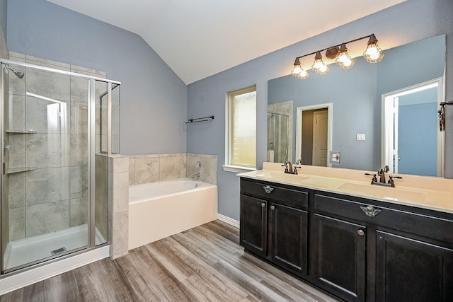 23014 Indigo Prairie Ln, Katy, TX 77493 - bathroom featuring a garden tub, a stall shower, lofted ceiling, double vanity, and wood finished floors