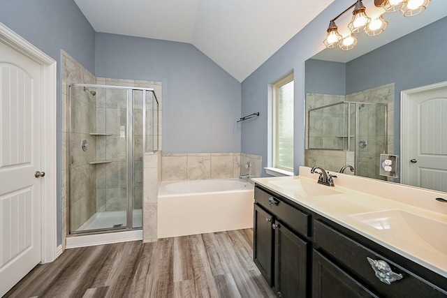 23014 Indigo Prairie Ln, Katy, TX 77493 - bathroom featuring a garden tub, wood finished floors, a shower stall, double vanity, and lofted ceiling