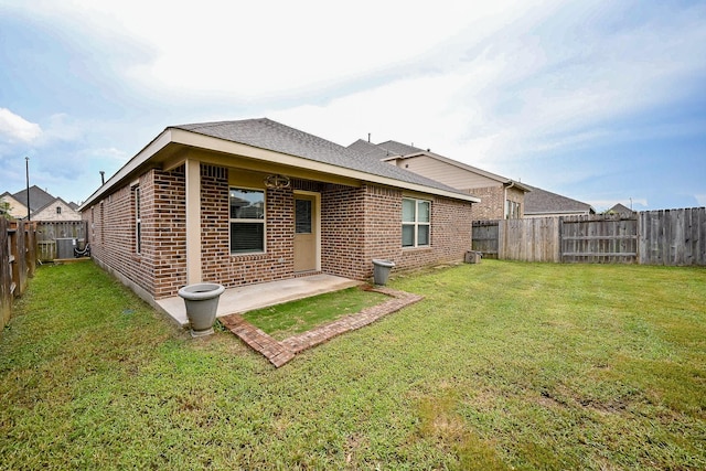 23014 Indigo Prairie Ln, Katy, TX 77493 - rear view of property with brick siding, a fenced backyard, and a patio area