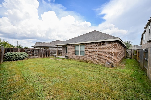 23014 Indigo Prairie Ln, Katy, TX 77493 - rear view of house with brick siding, a fenced backyard, and a shingled roof
