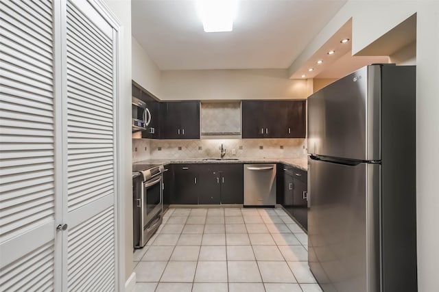 15 Greenway Plz Unit 5C, Houston, TX 77046 - kitchen featuring stainless steel appliances, decorative backsplash, light tile patterned floors, recessed lighting, and light stone counters
