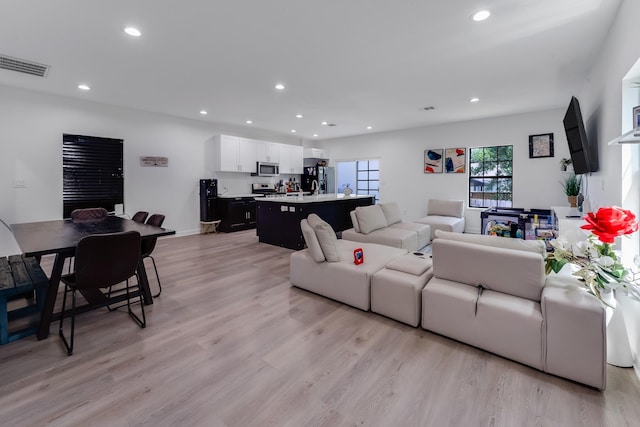727 E 40th St, Houston, TX 77022 - living room featuring recessed lighting and light wood finished floors