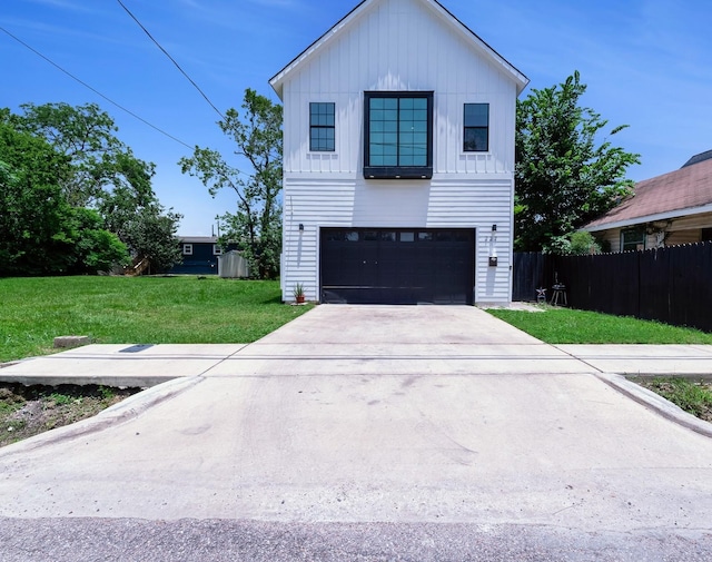 727 E 40th St, Houston, TX 77022 - view of front of house with board and batten siding, an attached garage, and concrete driveway