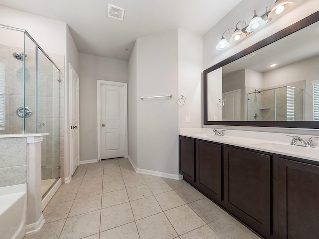 12519 Crathie Dr, Humble, TX 77346 - bathroom with a stall shower, double vanity, tile patterned flooring, and a tub