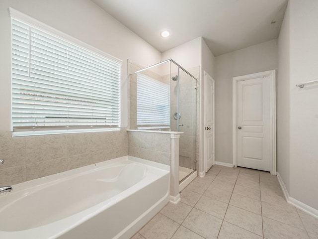 12519 Crathie Dr, Humble, TX 77346 - full bathroom featuring a bath, a stall shower, and tile patterned flooring