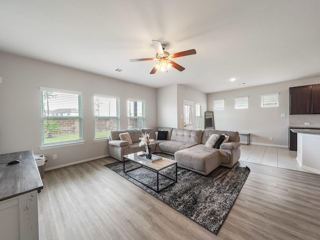 12519 Crathie Dr, Humble, TX 77346 - living area featuring healthy amount of natural light, light wood-style flooring, and ceiling fan