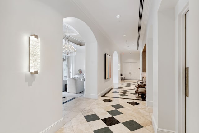 1100 Uptown Park Blvd Unit 23, Houston, TX 77056 - hall with arched walkways, a chandelier, ornamental molding, recessed lighting, and light tile patterned floors
