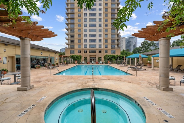 1100 Uptown Park Blvd Unit 23, Houston, TX 77056 - community pool featuring a hot tub, a pergola, and a patio area