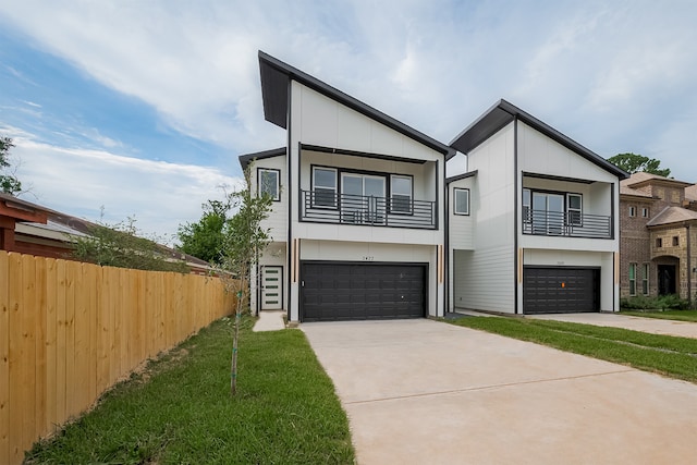 2422 Dalview St, Houston, TX 77091 - contemporary home featuring a garage, concrete driveway, and a balcony
