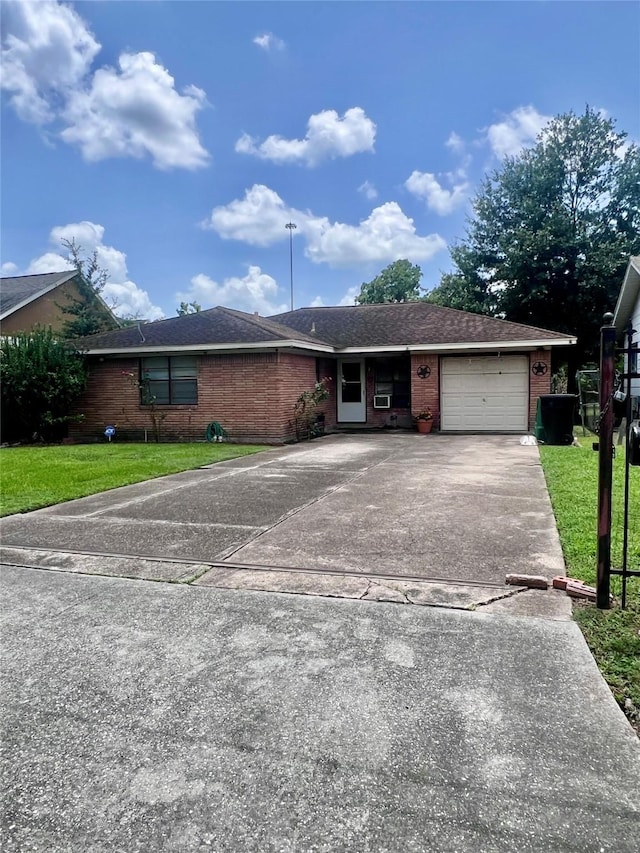 1410 Caplin St, Houston, TX 77022 - ranch-style house featuring concrete driveway, brick siding, a front lawn, and an attached garage