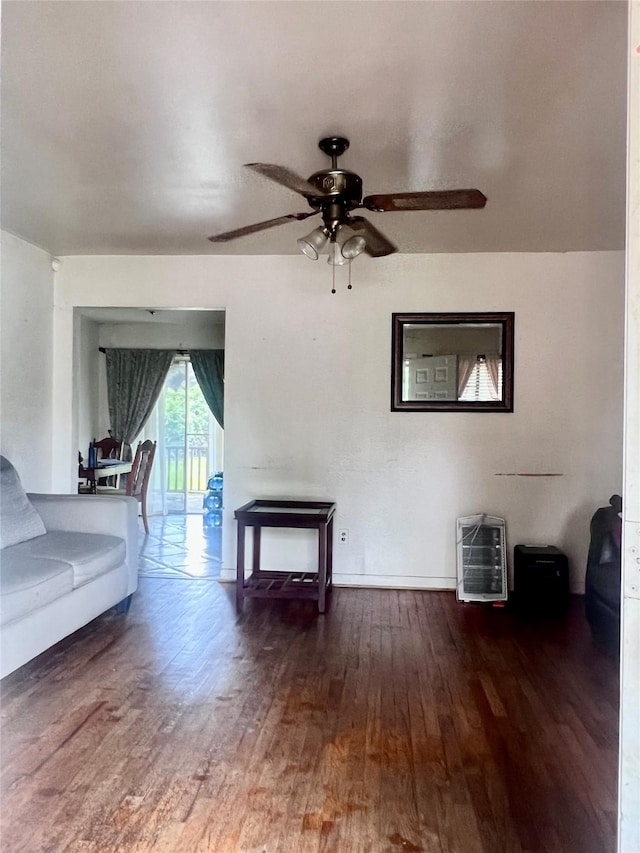 1410 Caplin St, Houston, TX 77022 - living area with wood finished floors, ceiling fan, and heating unit