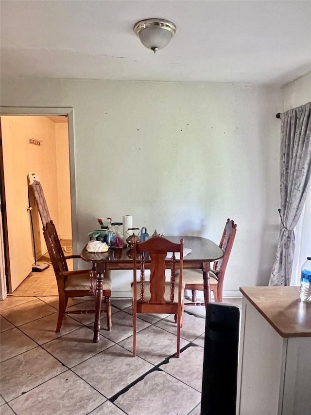 1410 Caplin St, Houston, TX 77022 - dining space with light tile patterned floors