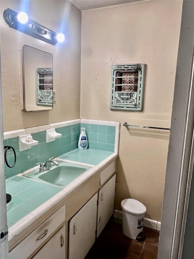1410 Caplin St, Houston, TX 77022 - bathroom with vanity, tile patterned floors, and decorative backsplash