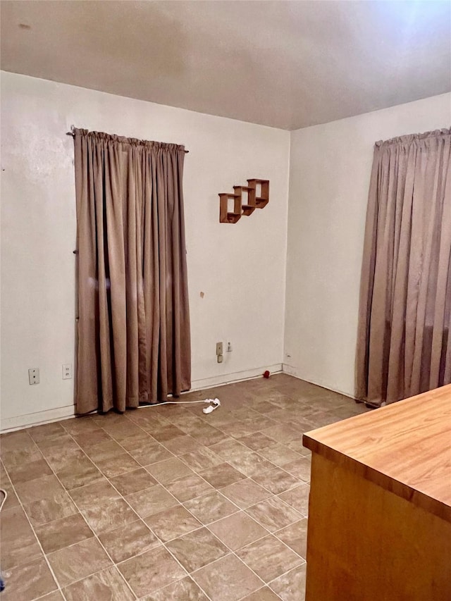 1410 Caplin St, Houston, TX 77022 - tiled empty room featuring baseboards