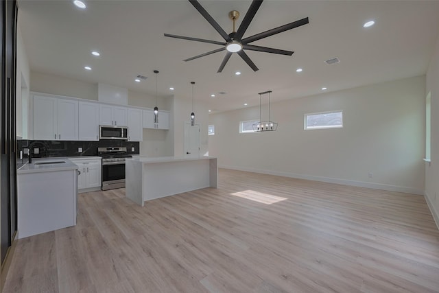 2420 Dalview St, Houston, TX 77091 - kitchen featuring stainless steel appliances, decorative backsplash, open floor plan, a kitchen island, and recessed lighting