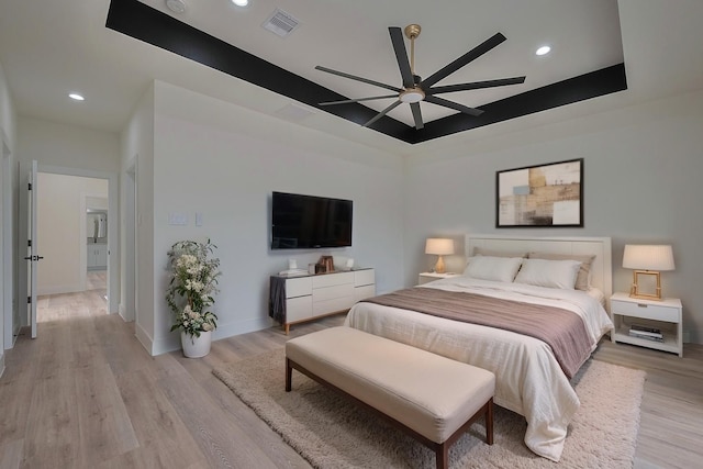 2420 Dalview St, Houston, TX 77091 - bedroom featuring light wood-type flooring, recessed lighting, a tray ceiling, and ceiling fan