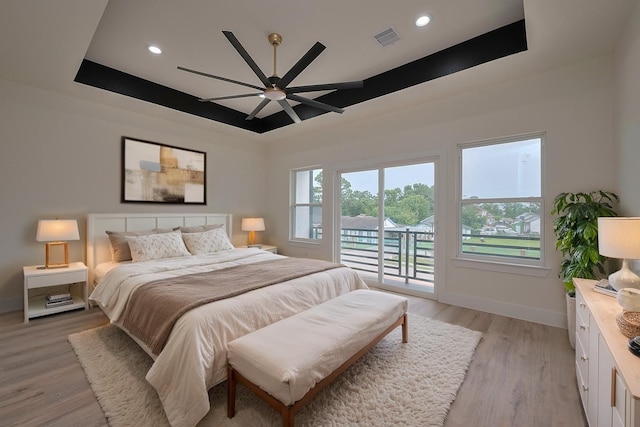 2420 Dalview St, Houston, TX 77091 - bedroom featuring access to outside, a tray ceiling, light wood-type flooring, recessed lighting, and a ceiling fan