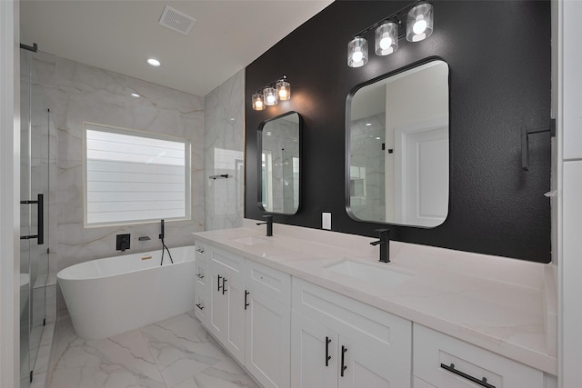 2420 Dalview St, Houston, TX 77091 - full bath with a soaking tub, double vanity, a stall shower, and marble look tile flooring