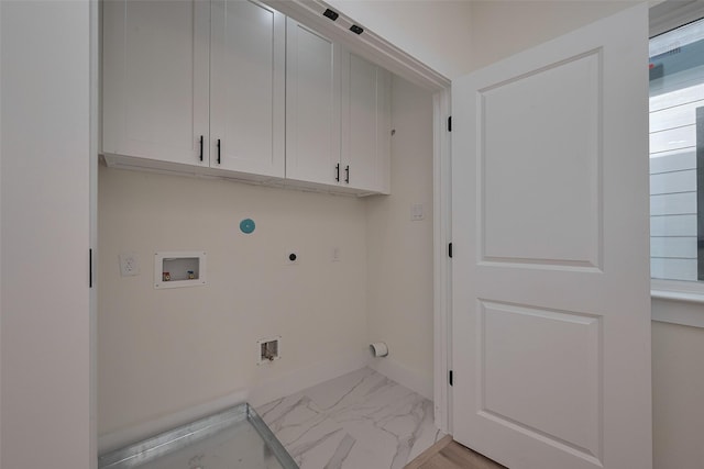 2420 Dalview St, Houston, TX 77091 - laundry room with electric dryer hookup, cabinet space, hookup for a washing machine, and light marble finish flooring